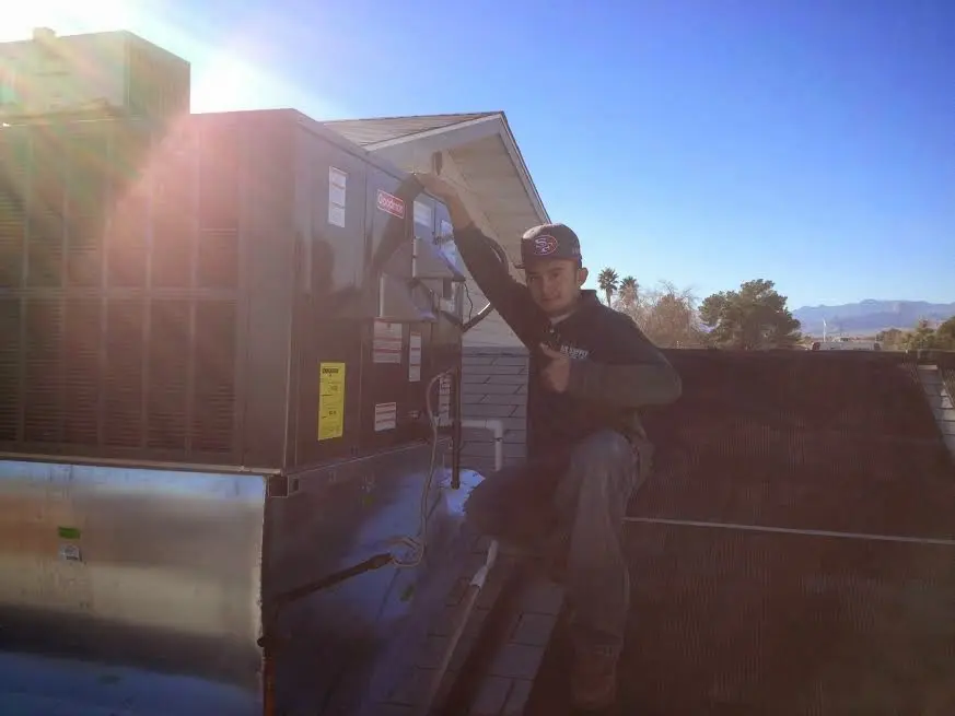 HVAC technician performing HVAC Inspection on a rooftop unit in Strongsville